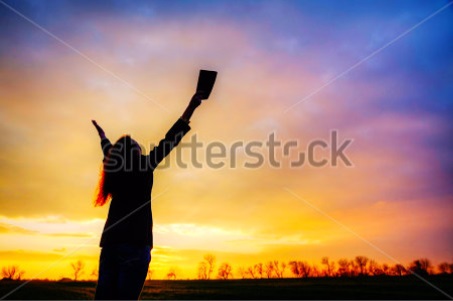Woman praying at sunset