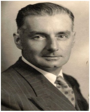 Black and white photo of man in suit, tie, white shirt