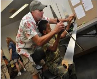 Man and boy playing the saw