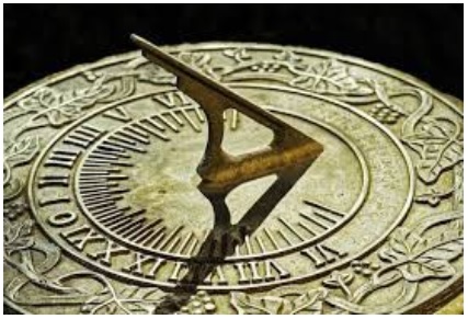 Golden sun dial casting a shadow
