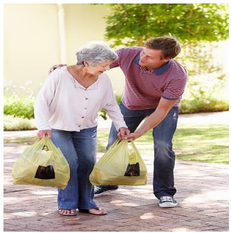 Man helping old lady carry shopping